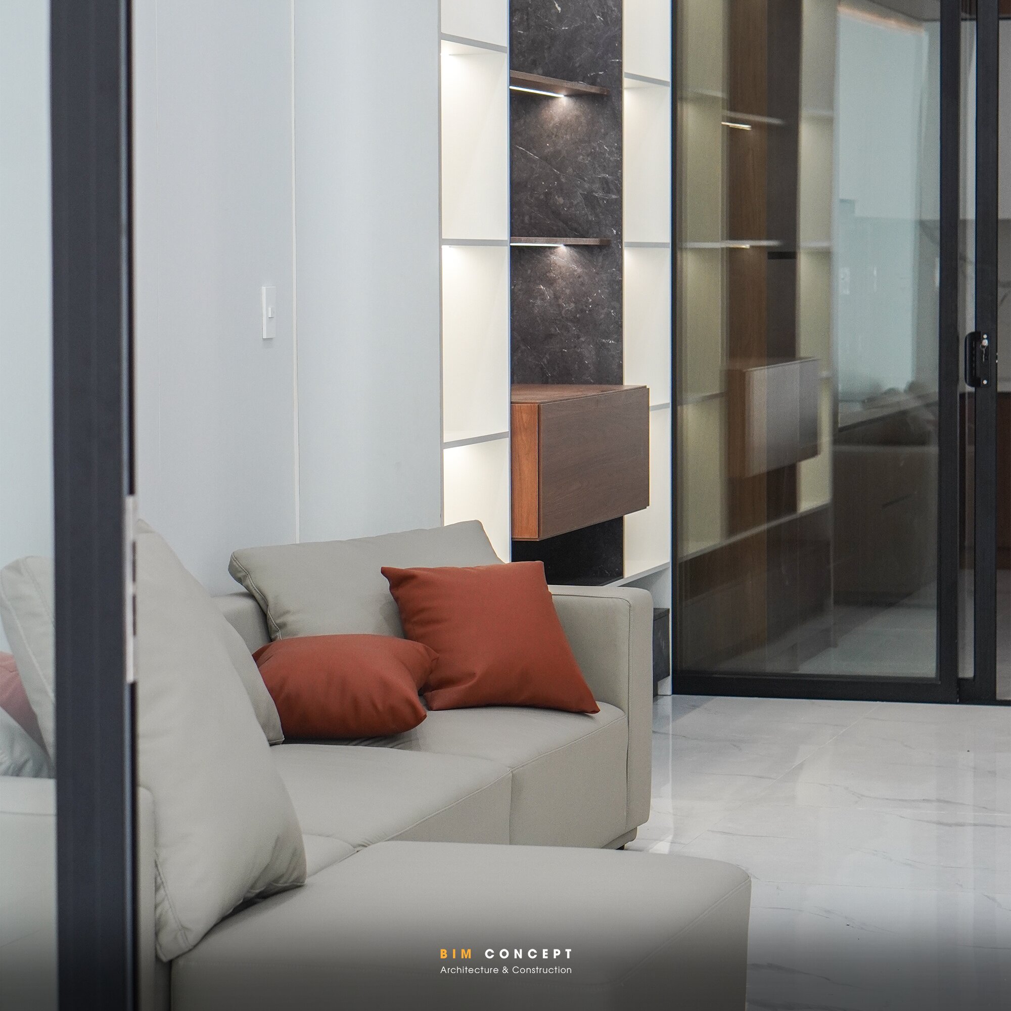 Sofa xám, kệ trang trí, cửa kính, thi công nội thất shophouse.